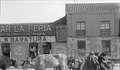 10. Tres hombres con sus animales de carga y carretas en la feria.